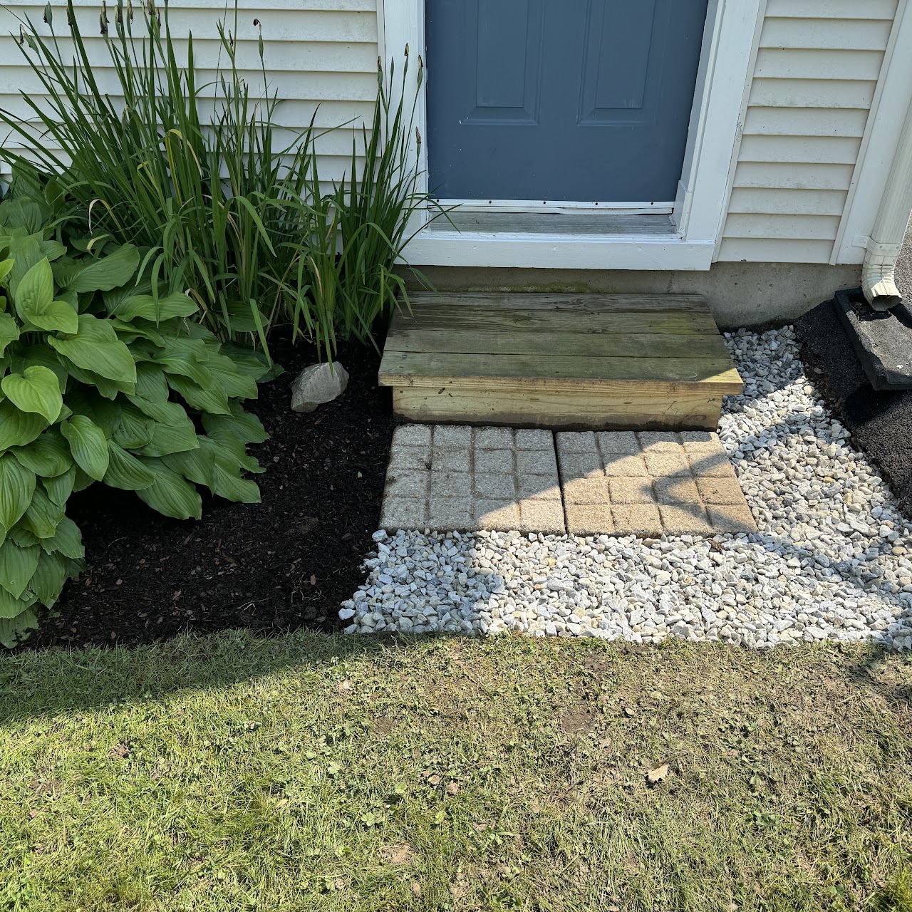 New paver walkway and gravel installed at a front entry step
