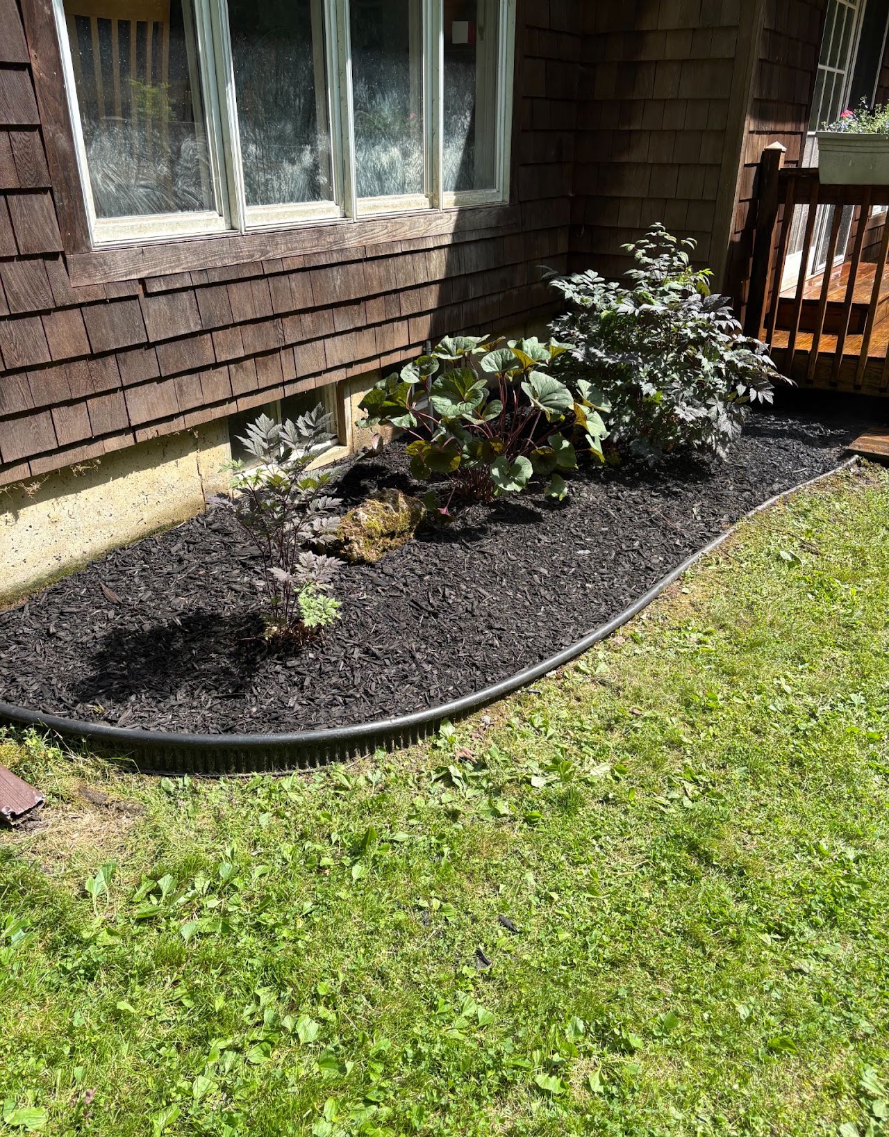Mulched foundation planting bed along a house exterior