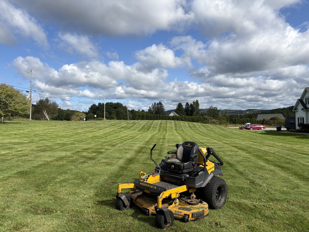 L&D stand-on mower on a freshly striped lawn