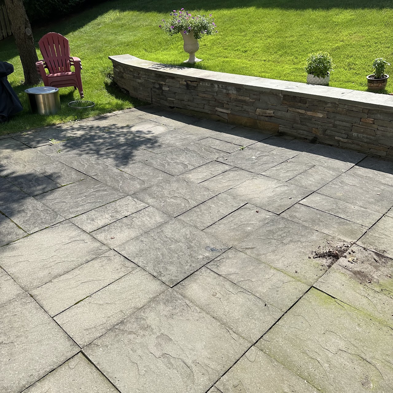 Dirty stone patio with moss and grime before pressure washing