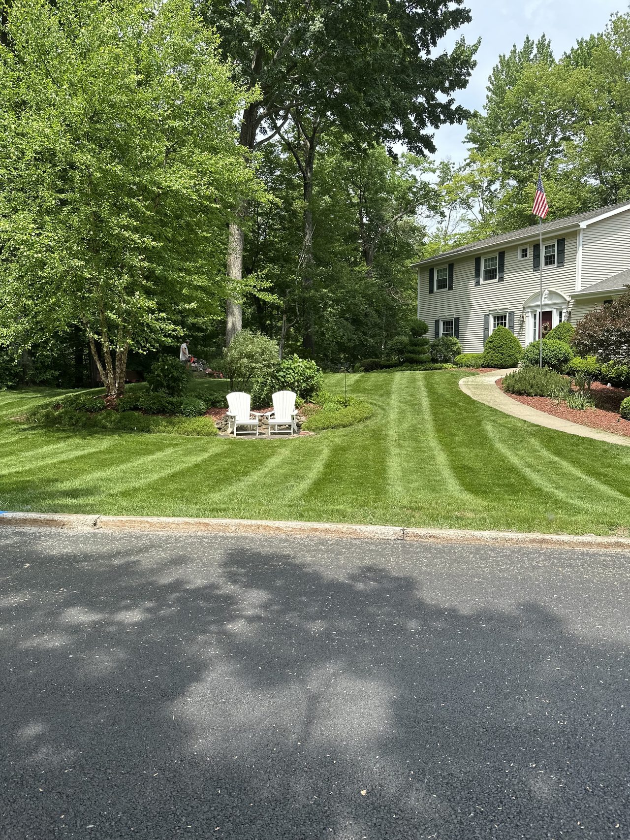 Freshly mowed front lawn with crisp striping by L&D Property Maintenance